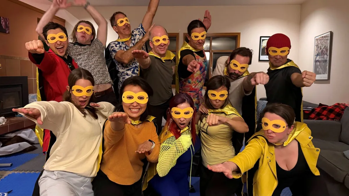 Joymaker alumni in superhero costumes