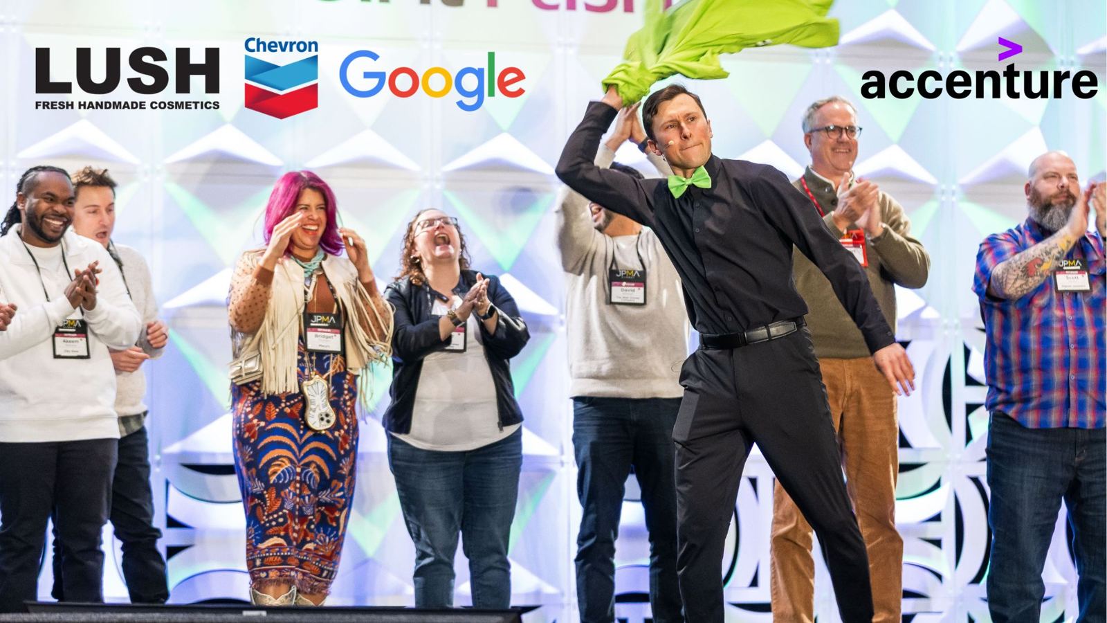 The Party Scientist on stage at a corporate event with LUSH, Chevron, Google, and Accenture logos